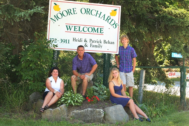 Behan Family photo with farm sign