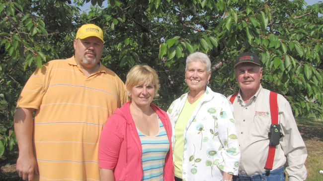 Mark, Barb, Marilyn and Hector Delanghe pose in front of sweet cherry trees on their farm, Delhaven Orchards, near Cedar Springs. The family-run business was named the Chatham-Kent feature industry of the month for June. (Blair Andrews/Postmedia Network)